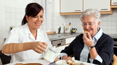 Heimhelferin sitzt mit älterer Frau beim Frühstückstisch © Gina Sanders, Fotolia.com