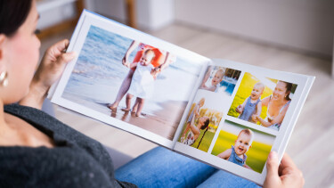 Eine Frau schaut sich ein Fotobuch an.